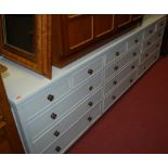 A contemporary painted low sideboard, fitted with multiple drawers, w.
