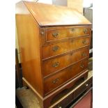 A reproduction mahogany slope front four drawer writing bureau