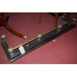 A late Victorian cast iron and brass fire fender,