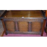 An early 20th century oak three panelled hinge-top blanket box, w.