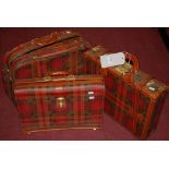 A tartan and leather bound briefcase;