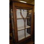 A 1930s oak ledgeback single door china display cabinet