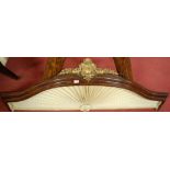 A mahogany and gilt metal crested canopy of shaped form