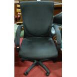 A contemporary upholstered swivel desk chair,
