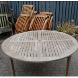 A teak circular patio table, dia 150cm,