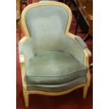 A pair of Louis XVI style cream painted and blue upholstered studded fauteuil