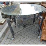 A wrought iron and glass topped patio table