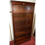 A reproduction mahogany freestanding open bookshelf, w.