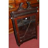 An Edwardian mahogany single door astragal glazed hanging corner cabinet