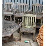 A weathered teak octagonal patio table together with eight matching elbow chairs