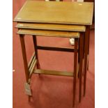 An Edwardian mahogany and satinwood crossbanded nest of three occasional tables