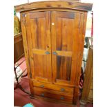 A contemporary stained pine double door wardrobe,