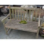 A weathered teak small garden bench