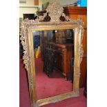 A large giltwood and gesso framed rectangular wall mirror, having floral basket surmount,