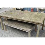 A weathered teak patio table together with a weathered teak patio coffee type table (2)