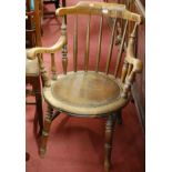 An early 20th century walnut stickback captain's chair,