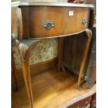 A walnut dropflap bowfront hinge-top dressing table,