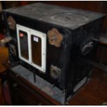 A black painted metal portable stove
