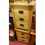 A pair of contemporary joined light oak three drawer bedside chests,