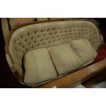 An early 20th century French beech framed and floral buttonback upholstered three seater canape