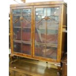 A 1930s flame mahogany double door glazed bookcase, w.