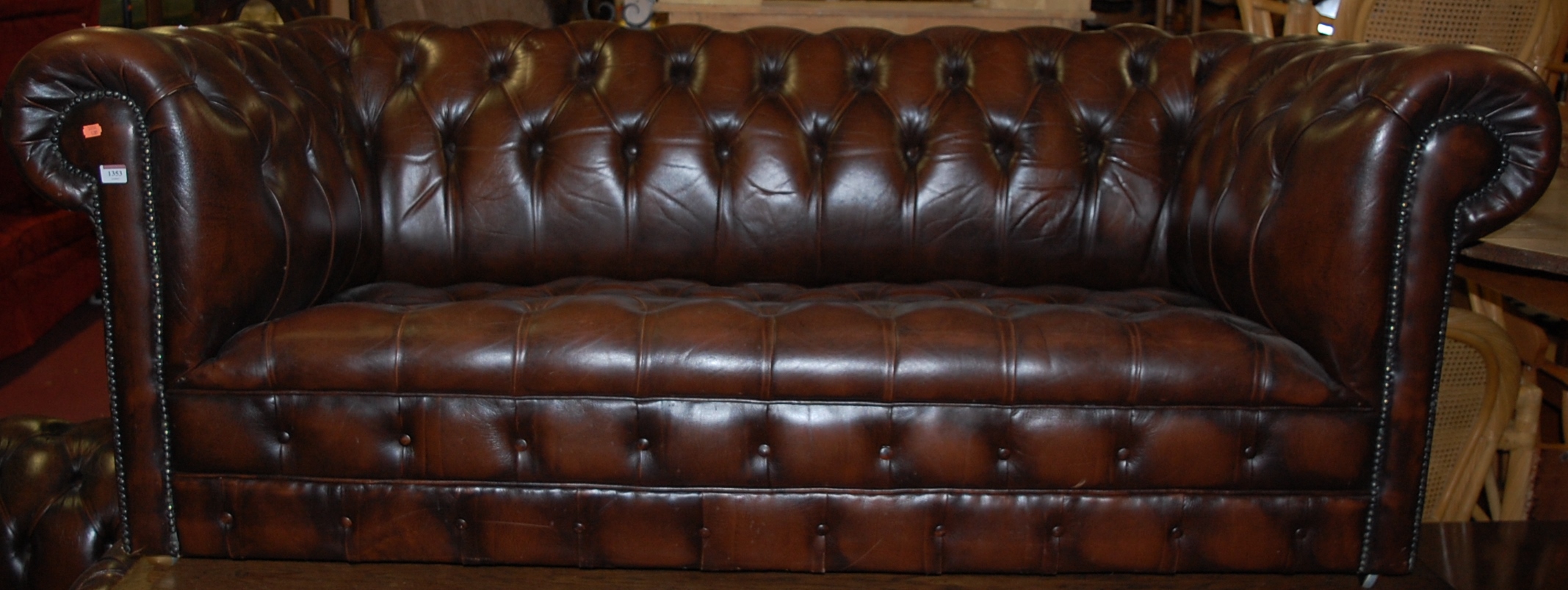 A contemporary tan leather and brass studded three seater Chesterfield, w.