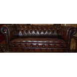 A contemporary tan leather and brass studded three seater Chesterfield, w.