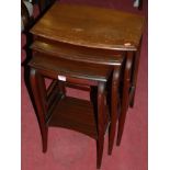 An early 20th century mahogany bowfront nest of three occasional tables, the largest w.