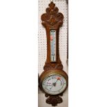 Circa 1900 carved oak aneroid wheel barometer
