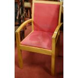 A pair of contemporary light oak and upholstered open elbow chairs