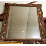 Circa 1900 carved oak framed and bevelled wall mirror,