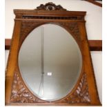 A late 19th century continental carved and bevelled oak framed wall mirror, h.