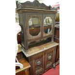 A circa 1900 Continental low relief carved oak bookcase cupboard,