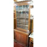 A 19th century mahogany bookcase cupboard, of narrow proportions,