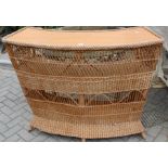 A wicker bow front small bar unit