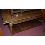 A good quality joined oak low two tier coffee table, having twin frieze drawers, w.