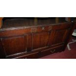 An 18th century provincial joined oak hinge-top three panelled mule chest,