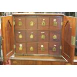 A circa 1900 walnut double door table-top collectors chest, fitted with twelve short drawers, w.