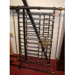 A Victorian style black painted wrought iron and brass kingsize bedstead,