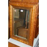 A contemporary satinwood framed rectangular wall mirror, of moulded form,