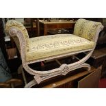 A Louis XVI style limewood and floral upholstered twin window seat, of X-framed scroll form,