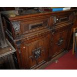 An antique joined and moulded oak four door side cupboard,