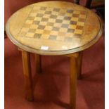 A walnut chessboard topper circular low occasional table