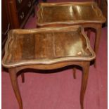 A pair of early 20th century Continental walnut shaped low occasional tables