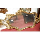 A Rococo style gilt gesso wall mirror,