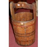 A stained pine and metal bound circular grain bucket with integral handle