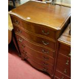 A mahogany serpentine front chest of six long drawers on splayed bracket supports,