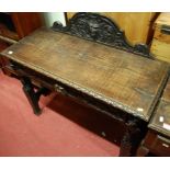 A circa 1900 heavily carved oak ledgeback single drawer side table,