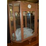 A 1950s laminate single door glazed clock display cabinet