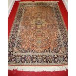 A Persian woollen blue ground rug, having a heavy field,